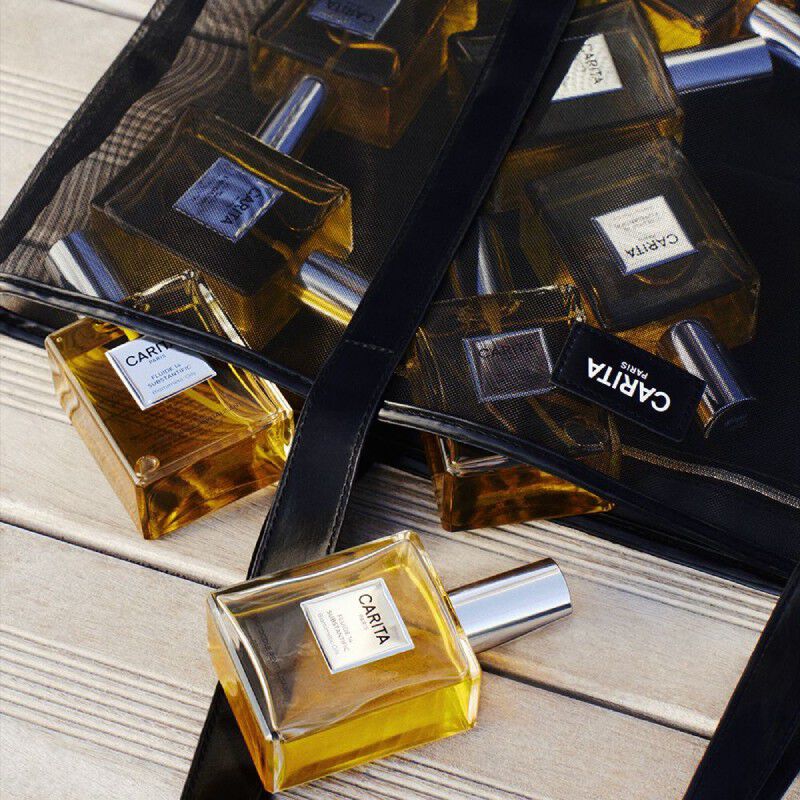 Trousse Carita et trois soins Or Rejuvenic dans des flacons noirs.​